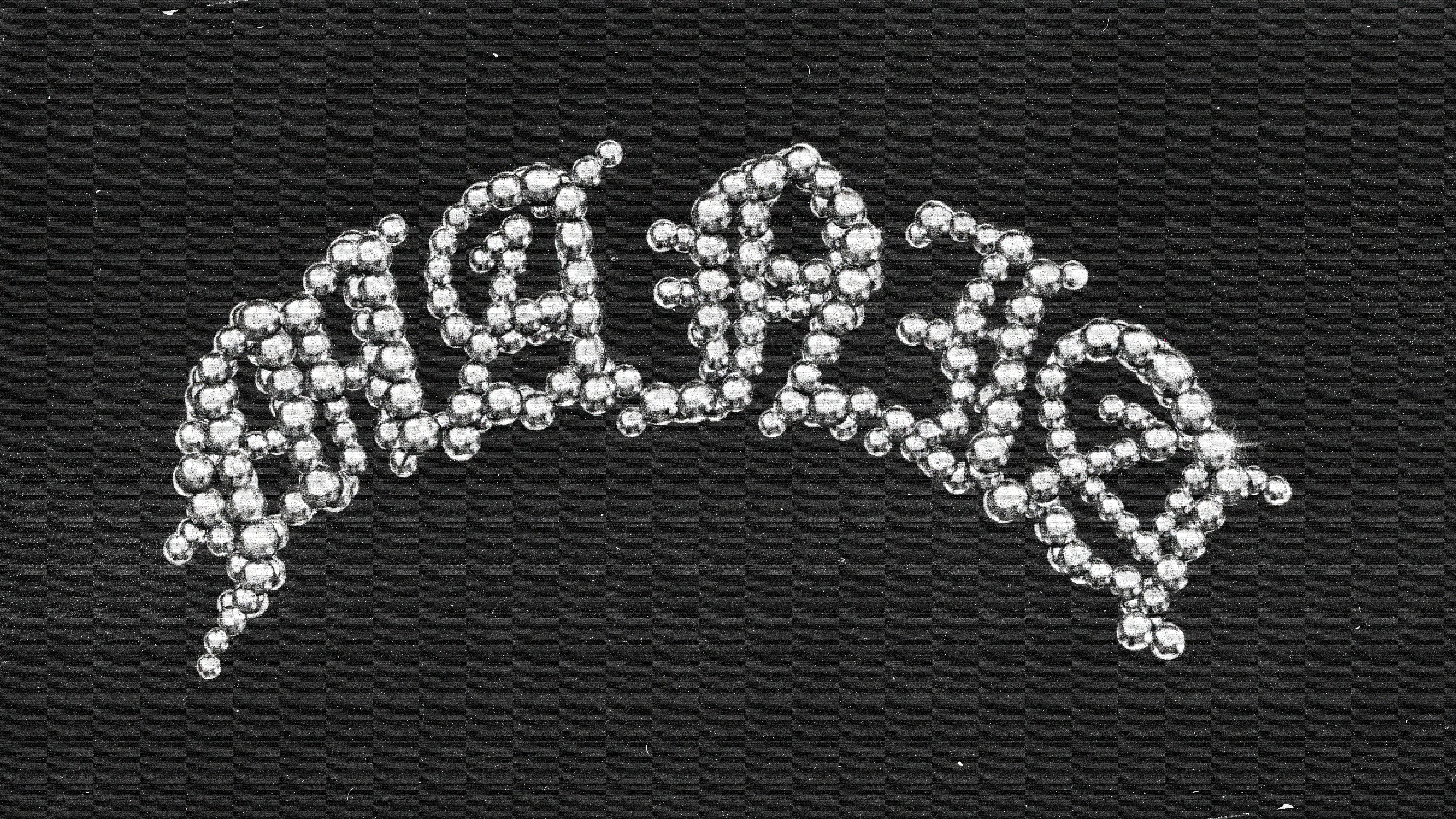 Logo Mania perlé en blanc sur fond noir.